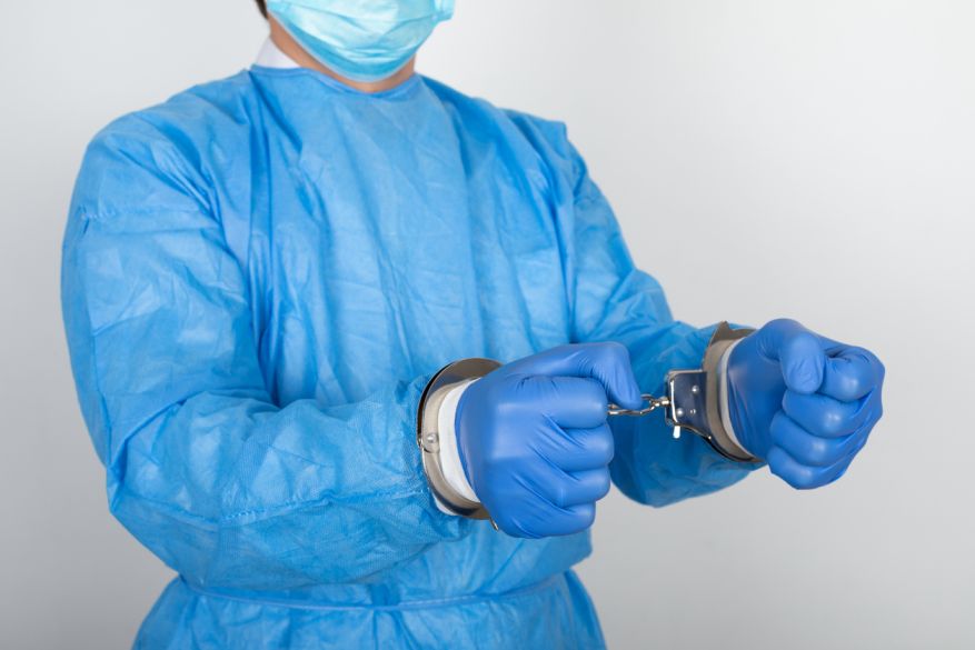 Medical professional in handcuffs, representing legal consequences for healthcare providers involved in medical malpractice leading to a patient's death.